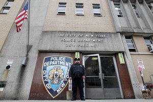 A police officer stands guard outside the 26th precinct where police officer Gilberto Valle worked in New York. Photo / AP