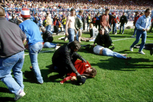 April 15, 1989 file photo, showing police, stewards and supporters as they tend to wounded soccer supporters on the field at Hillsborough Stadium, in Sheffield, England. Photo / AP