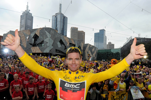 Cadel Evans celebrates with fans after winning last year's Tour de France. Photo / Getty Images