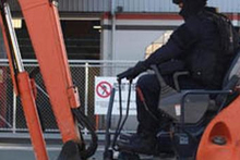 Police used a digger to smash into the Red Devils HQ in Nelson. Photo / Supplied 