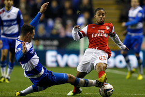 Reading's Sean Morrison, left, vies for the ball with Arsenal's Jernade Meade during the English League Cup soccer match between Reading and Arsenal at Madejski Stadium in Reading. Photo / AP