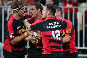 Canterbury player Tom Taylor celebrates after scoring his first try with team mates. Photo / Getty Images.