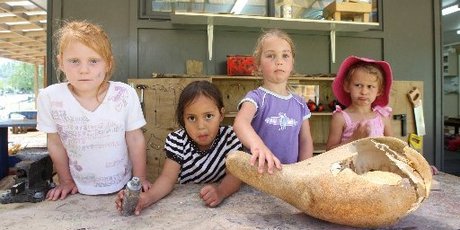 Amber Gleeson, Nevaeh-Lee Matiu,3, Isabella Troughton,4, and Sangreal Ekins, 3, of Maungaarangi Kindergarten with a gourd that was smashed by vandals. Photo / Joel Ford