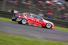 Greg Murphy and Jack Perkins show winning style as they speed past the grandstands at Pukekohe yesterday. Photo / Sarah Ivey