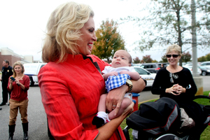 Ann Romney, wife of Republican presidential candidate, Mitt, holds eight-month-old Taylor Roundtree during a campaign stop at the Back Bay Gourmet in Virginia Beach. Photo / AP