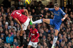 Chelsea's Fernando Torres, right, competes with Manchester United's Rio Ferdinand. Photo / AP