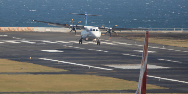 An Air New Zealand ATR-7 aircraft landing in strong winds at Wellington Airport. Photo / Mark Mitchell