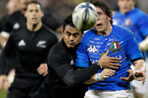 Italy's Mirco Bergamasco is hit hard in the tackle of New Zealand's Isaia Toeava in a 2009 test. Photo / NZPA File