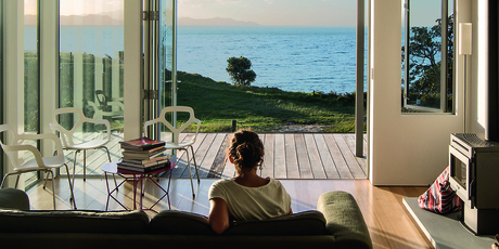 The Otama Beach bach's deck overlooks the ocean. Photo / Patrick Reynolds