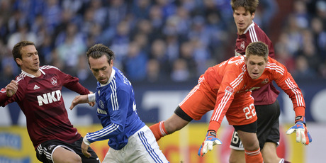 Total Football: Nuremberg's goalkeeper Patrick Rakovsky, right, and Schalke's Christian Fuchs challenge for the ball during the German first division Bundesliga match between Schalke and Nuremberg. Photo / AP