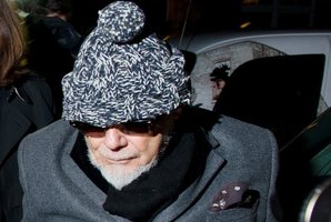 Former British rock star Gary Glitter, whose real name is Paul Gadd, returns home in central London after he was arrested earlier in the day by British police. Photo / AFP