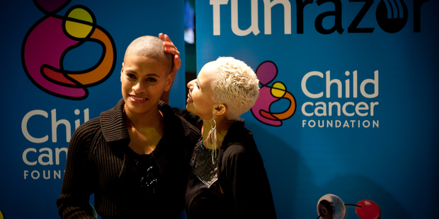Megan Alatini admires Vilomena Ole's shaved head yesterday. Pictures / Dean Purcell