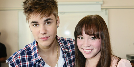 Justin Bieber, pictured with Starship patient Makenzie Perry, is helping to promote the hospital's festive-season album.