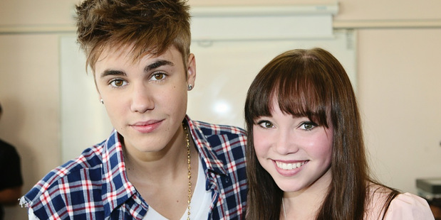 Justin Bieber, pictured with Starship patient Makenzie Perry, is helping to promote the hospital's festive-season album.