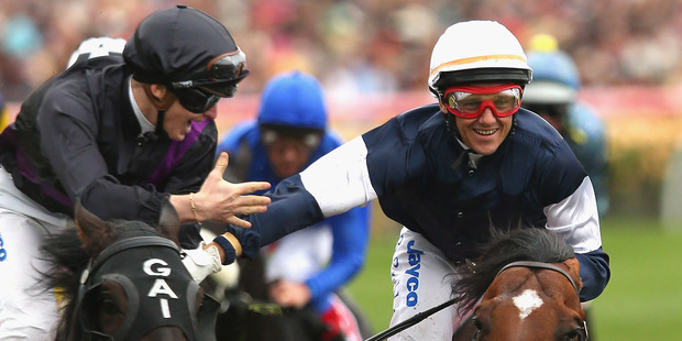In a great display of sportsmanship James McDonald (left) aboard runnerup Fiorente congratulates Brett Prebble who won the Melbourne Cup on Green Moon. Photo / Getty Images