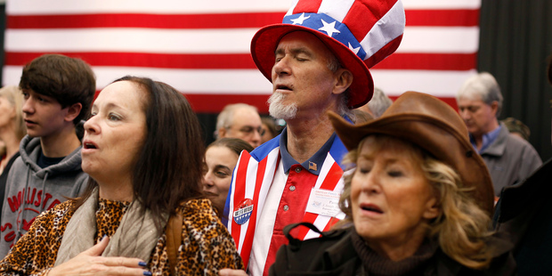 Supporters of Mitt Romney pray before the arrival of their candidate at a campaign rally in Cleveland. Photo / AP