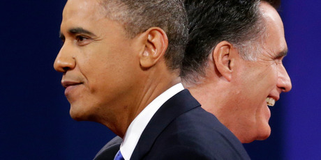Republican presidential candidate Mitt Romney and President Barack Obama walks past each other on stage at the end of the last debate at Lynn University. Photo / AP