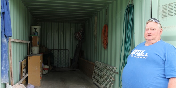 Allan Clarke, president of the Giants Softball Club, shows the empty shipping container after thieves stole around $5000 worth of gear from it. Photo / APN