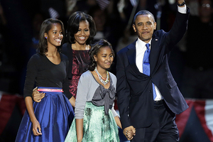 President Barack Obama waves as he walks on stage with first lady Michelle Obama and daughters Malia and Sasha at his election night party. Photo / AP