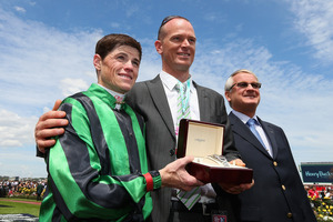 Craig Williams who rode Alcopop and trainer Jake Stephens pose with the trophy after winning the Mackinnon Stakes. Photo / Getty Images