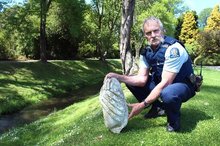 Oamaru police Community Constable Bruce Dow is seeking information from the public to identify this piece of Oamaru stone from a statue. Photo / Rebecca Ryan