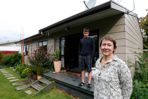 Antoinette van der Weerden, with her son Soloman Caldswell, says she noticed the difference the insulation made straight away. Photo / Christine Cornege