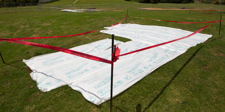 Sacking and plastic sheeting has been placed over areas of Glendowie Park. Photo / Steven McNicholl