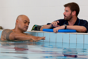 Oscar Kightley (left) sets an example with a swimming lesson from instructor Andrew Brown. Photo / Steven McNicholl