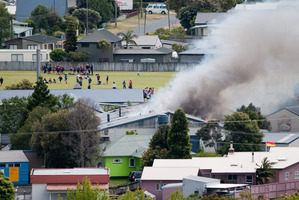 Flames and smoke rose 3m above the roof of the burning workshop. Photo / Daniel Davie