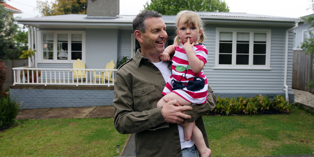 Phil Holden and daughter Lila outside their home in Mark Rd, Mt Albert that sold at auction recently. Photo / Doug Sherring