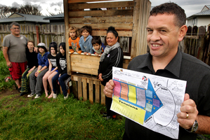 Whanau Ora worker Dean James (right, front) pictured at the Smith family home in Rotorua. Photo / Alan Gibson