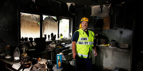 Fire investigator Gary Beer inspects the damage in a Hikurangi home after a fire believed to have originated in a drier. Photo / Michael Cunningham