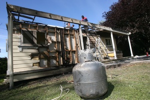 Hot ashes re-ignited to cause a fire at this Papatahi Rd, Western Lake, cottage. Photo / Lynda Feringa