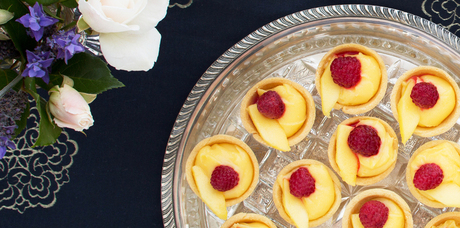 Lime curd tartlets with mango and raspberries. Photo / Babiche Martens