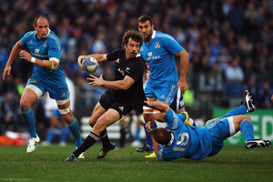 Man of the match Conrad Smith offloads during a commanding performance in the Italy test at Stadio Olimpico. Photo / Getty Images