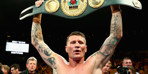 Danny Green celebrates with the belt after winning the world title bout of Australia against Shane Cameron. Photo / Getty Images
