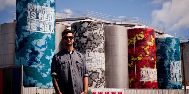 Elliot O'Donnell, also known as Askew One, has painted eight tanks featuring CK Stead's Auckland. Photo / Dean Purcell