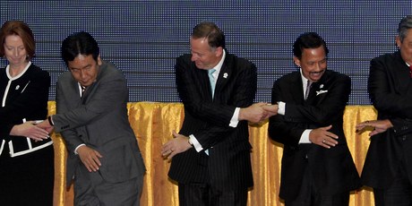 The gathered leaders, including John Key, pose for photographers as they perform a group handshake in Phnom Penh Cambodia as part of the 21 st ASEAN Summit. Photo / Alan Gibson