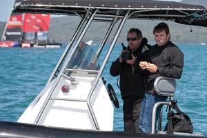 As Team NZ and Luna Rossa race (above), Simon Daubney, of Ben Ainslie Racing, keeps watch. Photo / Greg Bowker