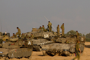 Israeli soldiers gather with their tanks and bulldozers in a gathering area near the Israel Gaza Strip border, in southern Israel. Photo / AP