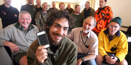 Chilean tourist Ignacio Falk with some of the Search and Rescue volunteers that rescued him from the Tararua Ranges. Photo / Lynda Feringa