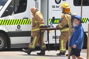 Hastings firemen carry what was believed to be the cause of an explosion or fire at Mayfiar School, Hastings. Photo / Warren Buckland