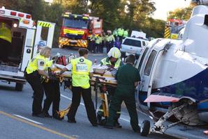 Ambulance crew attend to one of the victims involved in the fatal crash between Whangarei and Kawakawa. Photo / APN