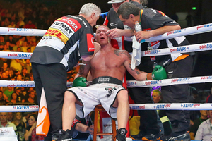 Shane Cameron is seen to by his trainers during his world title bout against Danny Green. Photo / Getty Images