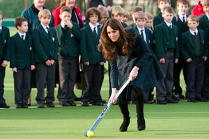 Kate, the Duchess of Cambridge, centre, plays hockey during her visit to St. Andrew's School. Photo / AP