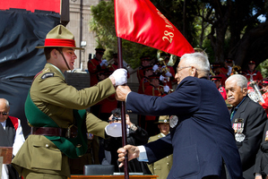 Surviving members of the Maori Battalion and president Nolan Reihana hands over the Maori Battalion flag during the ceremony. Photo / Marty Melville
