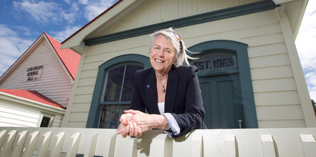 Kaukapakapa resident Carol Forsyth outside the library and community hall built in 1860. Photo / Natalie Slade