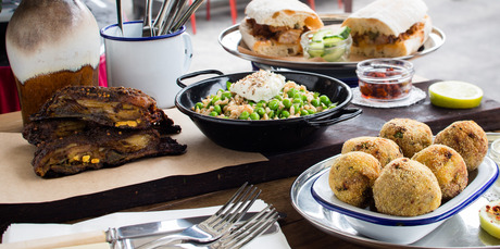Krokety with lime and aioli, wood roasted lamb ribs with mint, lemon, pea spelt and labne and harissa sauce and pork roll with pickled cucumber. Photo / Babiche Martens