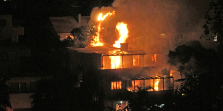 The sole occupant was rescued by neighbours, but suffered extensive burns. Photo / Christine Prestwood