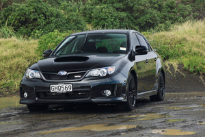 This shot shouldn't work because the day is dull, the background and foreground are cluttered and black cars often don't photograph well, but they combine to suit the brooding `bad boy' Subaru WRX very well. Photo / Phil Hanson
